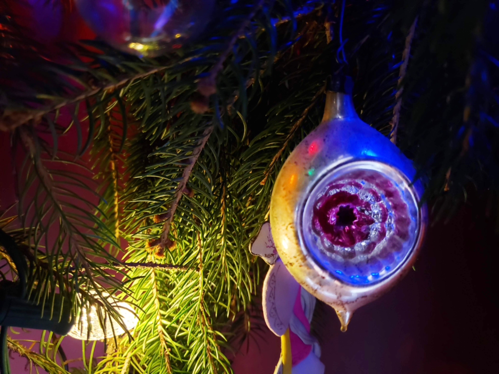 Vintage glass ornament on an evergreen tree